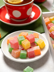 A plate of sweet multi-colored sweets marmelado lucuma. tea party with refreshments for you.