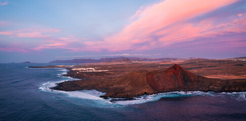 aerial view of village at volcano at coast during colorful sunset 