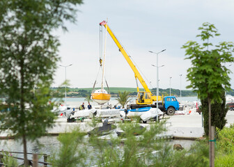 crane lifting a boat in the harbor