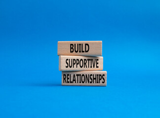 Build Supportive Ralationships symbol. Wooden blocks with words Build Supportive Ralationships. Beautiful blue background. Business and Build Supportive Ralationships. Copy space.