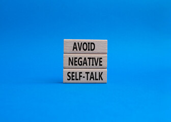 Avoid negative self-talk symbol. Concept words Avoid negative self-talk on wooden blocks. Beautiful...