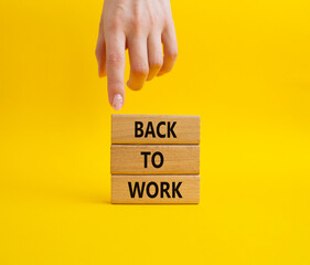 Back to Work symbol. Wooden blocks with words Back to Work. Beautiful yellow background. Businessman hand. Business and Back to Work. Copy space.