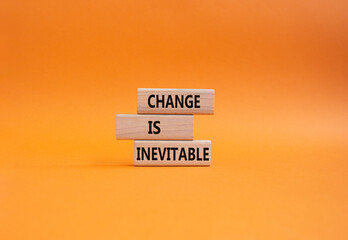 Change is Inevitable symbol. Wooden blocks with words Change is Inevitable. Beautiful orange background. Business and Change is Inevitable concept. Copy space.