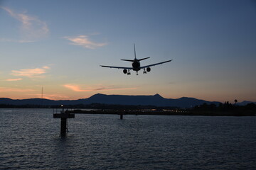 Fototapeta na wymiar Aircraft approaching Corfu International Airport. Corfu island, Greece