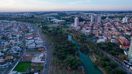Fototapeta na wymiar Indaiatuba Ecological Park. Beautiful park in the city center, with lake and beautiful trees and houses. Aerial view