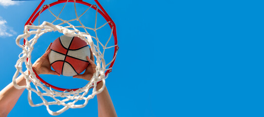sport success. scoring while basketball game. ball goes through basket. Horizontal poster design. Web banner header, copy space. © Olena