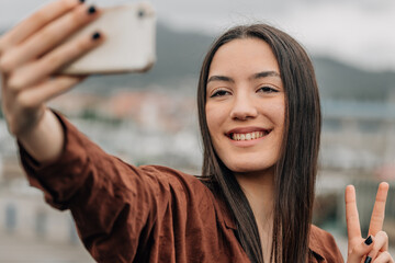 girl on the street with mobile phone taking photo