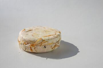 Close up of a shampoo bar with shadow on white background