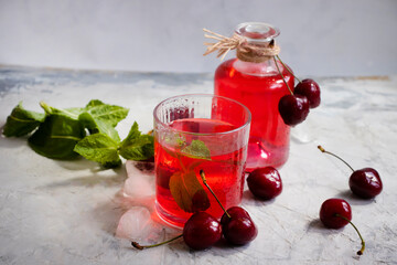 Cherry juice, fresh berry on a light background