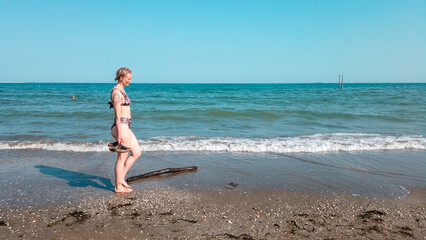 Fototapeta na wymiar Woman walking on the beach.