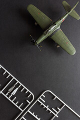 Scale model of a fighter aircraft with details and tools. Plastic assembly kit