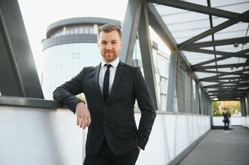 Portrait of an handsome businessman in an urban setting