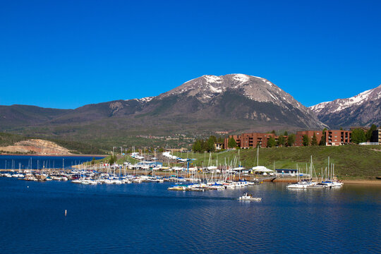 Marina and Rocky Mountain peaks at Dillon Reservoir at dawn in spring