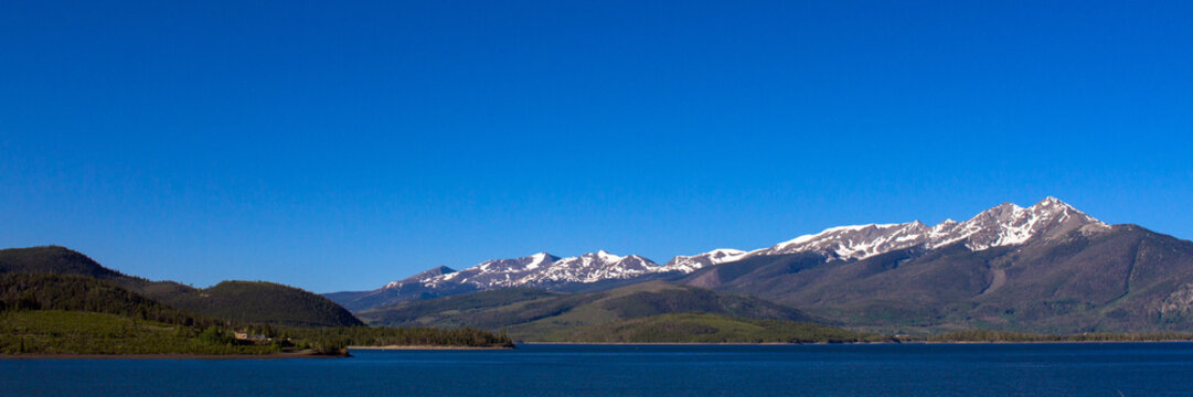 View of the Rockies from across Dillon Reservoir at dawn in spring
