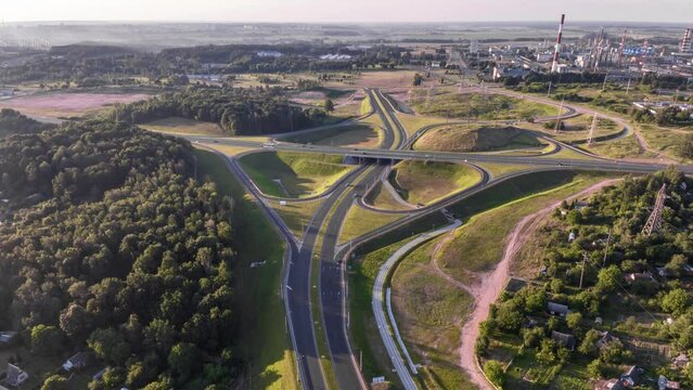 aerial hyperlapse of road junction with heavy traffic in forest