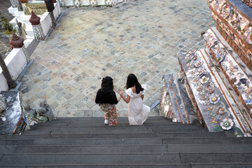 Friends descending the stairs in an ancient Buddhist temple