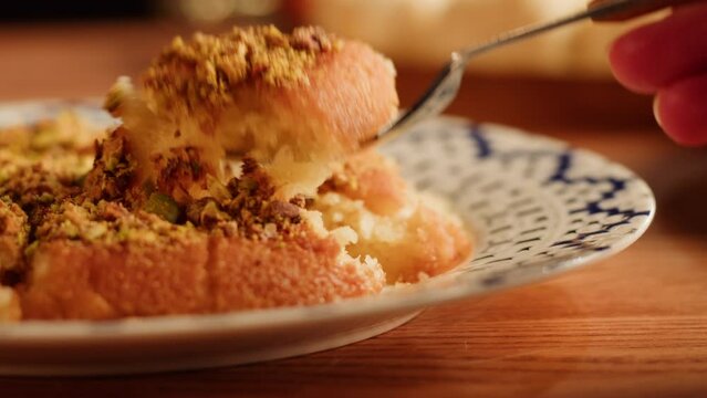 Arabic traditional sweets, kunafa dish close-up. Middle eastern national food desserts. Muslim family dinner, Ramadan, iftar. Arabian cuisine delivery.