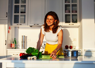 real cheerful lady on kitchen preparing dinner, lifestyle people concept