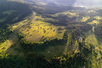 Aerial view of mountains covered with coniferous forests. Aerial View Landscape Mountain. Breathtaking aerial view of the tall mountains covered by the forest. Sunrise