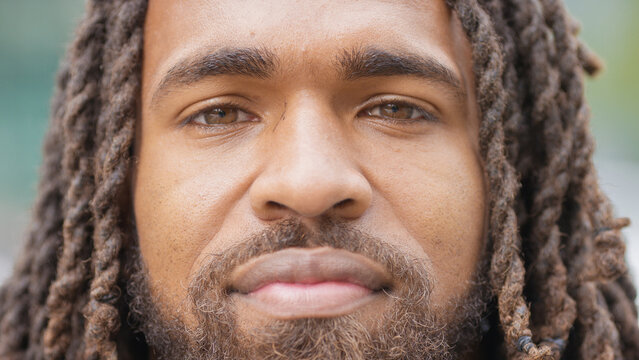 Close portrait of attractive black male looking directly to camera 
