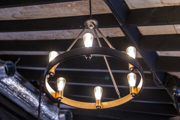 A rustic hanging mid-evil type light fixture or lantern hung from a high ceiling