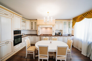 The interior of a large and spacious kitchen-living room in a classic style. 