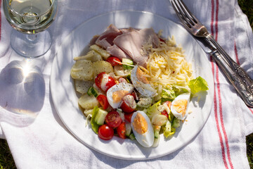 Simple summer meal with potatoes, salad, egg, cheese and ham