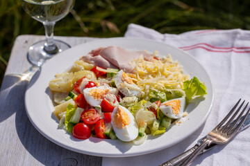 Simple summer meal with potatoes, salad, egg, cheese and ham