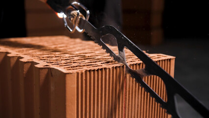 Close up of electric cutting machine for small ceramic blocks beginning cutting process. Stock...