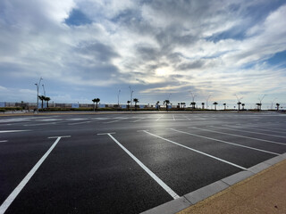 Empty parking lot with sunrise sky in the background