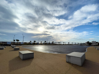 Empty parking lot with sunrise sky in the background