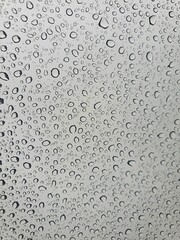 Raindrops on the top window (glass).
Water drops on background.