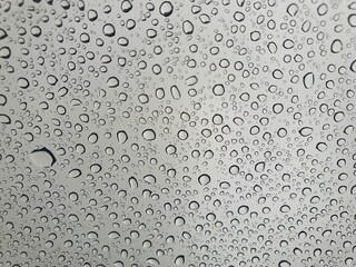 Raindrops on the top window (glass).
Water drops on background.