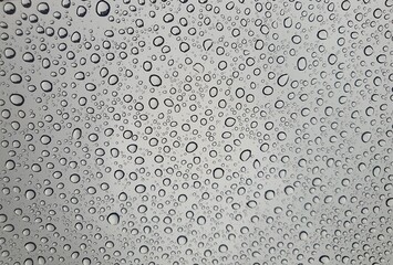 Raindrops on the top window (glass).
Water drops on background.