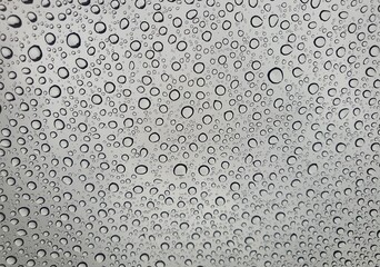 Raindrops on the top window (glass).
Water drops on background.