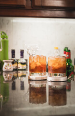 bartender preparing Manhattan drink with cherry and ice
