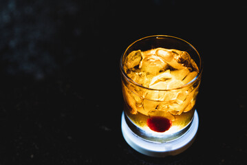 bartender preparing Manhattan drink with cherry and ice
