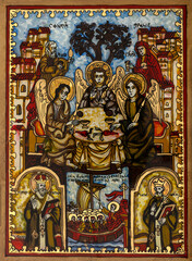 Obraz premium Icon painted on reverse glass in the naive orthodox style of Eastern Europe depicting the Holy Trinity.