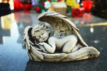 Close up of angel figurine sleeping on the grave