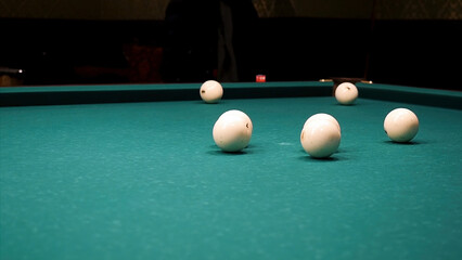 Balls of different number, type, diameter, color, and pattern on a billiard table, billiards table, or pool table covered with green cloth. Balls on a billiard table. White snooker ball on the pool