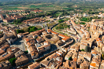 Fototapeta na wymiar Drone view of historical part of Tarazona city with ancient bullfight arena and medieval cathedral with seminary on sunny spring day, Spain