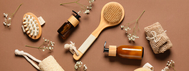 Composition with massage brushes and bath supplies on brown background, top view