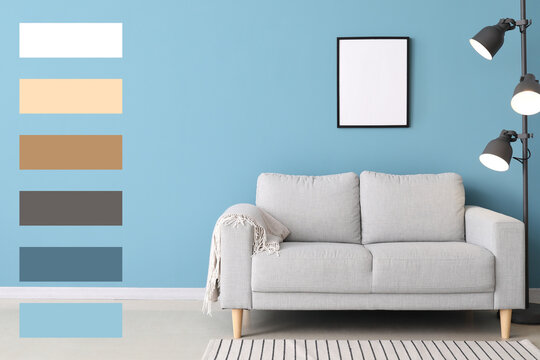 Stylish sofa and lamp near blue wall. Different color patterns
