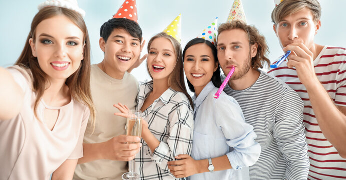 Group of friends taking selfie at Birthday party