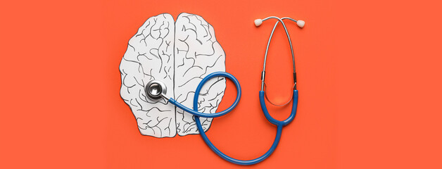 Paper brain and stethoscope on orange background. Concept of brain diseases - obrazy, fototapety, plakaty