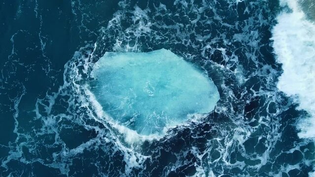 Iceberg in the ocean, Huge Chunks of Blue Ice floating on the waves, Arctic landscape aerial view, clean water, global warming and climate change concept