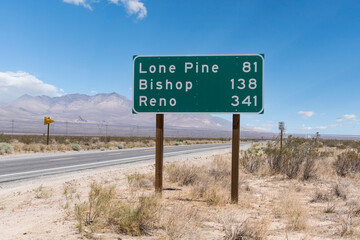 Highway sign to Lone Pine, Bishop and Reno on scenic US Route 14 in the Mojave desert area of...