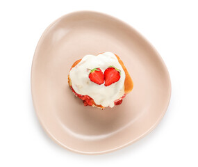 Plate with strawberry cinnamon roll and cream on white background