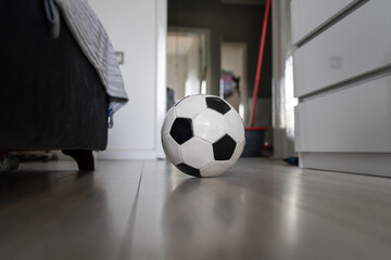 soccer football ball on the floor in bright room in day no people copy space