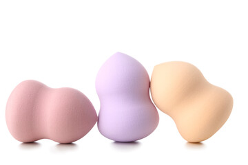 Colorful makeup sponges on white background